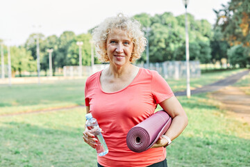 Portrait of a middle aged beautiful sport woman smiling happy and confident. Standing with smile on...