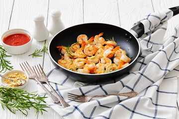 rosemary and garlic seared shrimps in a skillet