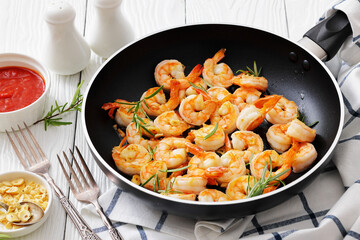 rosemary and garlic seared shrimps in a skillet