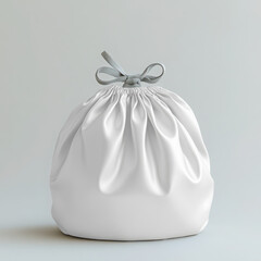A white satin drawstring gift bag with a silver ribbon bow, isolated on a light gray background transparent mockup 