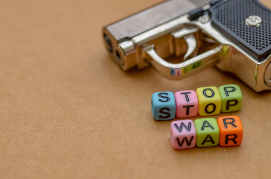 The stark contrast of the phrase "STOP WAR" against the looming silhouette of a handgun creates a powerful and poignant visual plea against global conflict.