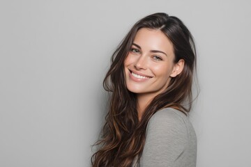 Fototapeta premium Woman with Long Hair Smiling on Light Grey Background