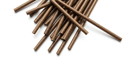 Close up of numerous brown cylindrical objects arranged on white background