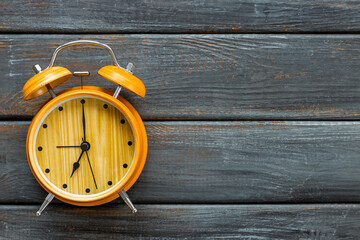 Vintage wooden alarm clock with bells at seven o'clock. Morning routine. In time concept