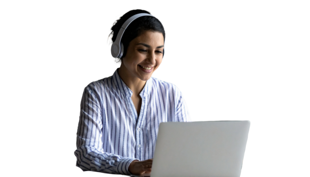 Young Indian woman with headphones smiles working on laptop at home desk. Engaging in online education, business, communication. Student learning lesson, attending virtual meeting class