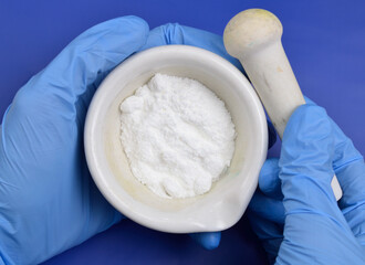 Caffeine powder on the light gray background