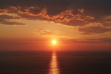 Fototapeta premium Vibrant Sunset Over Ocean Horizon Illuminated By Golden Sunlight and Reflecting on Calm Water Surface