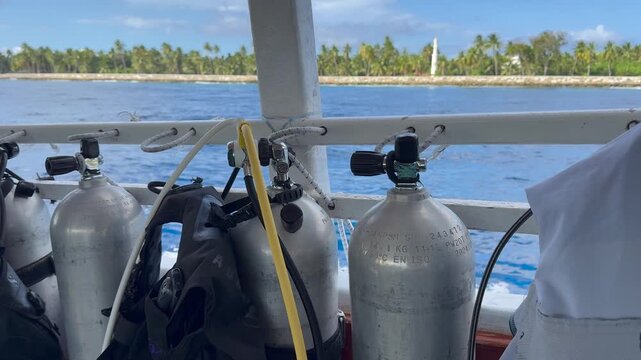 Dive Boat with Scuba Cylinders Sailed Towards the Dive Site. Boat Diving. Scuba Diving Tourism. Scuba diving tanks and equipment secured on a dive boat. Health Benefits of Scuba Diving.