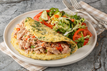 Healthy canned tuna omelette with vegetable salad close-up in a plate on the table. Horizontal
