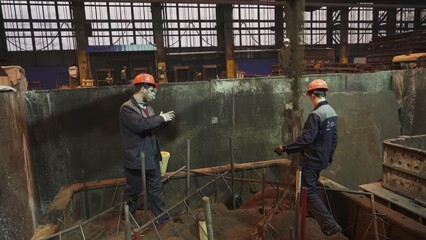 Foundry workers preparing sand mold. Stock clip
