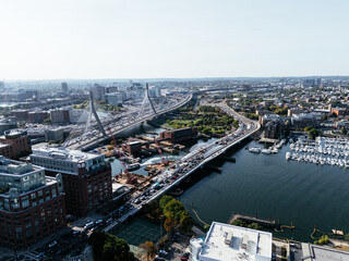 Fototapeta premium Aerial view of Boston city, bridges and river with skyline in sunlight. g.