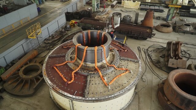 Induction heating of large industrial mill housing in factory. Stock clip