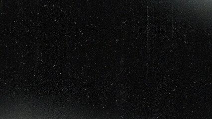 Black grunge film texture with dust, scratches, and grain, creating a vintage cinematic overlay. Ideal for retro photography effects, video overlays, and distressed graphic design backgrounds.