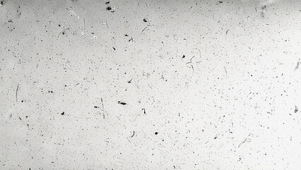 Vintage film grain overlay texture with dust and scratches, monochrome distressed surface. Ideal for retro photography effects, video overlays, and digital design projects.