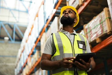 Warehouse, engineer and black man with tablet for planning storage, distribution or check stock of...