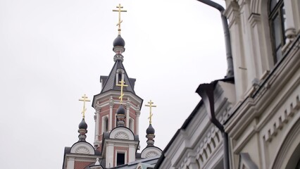 Fototapeta premium Golden crosses shining on russian orthodox church domes. Action