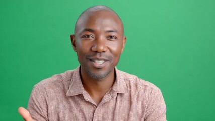 Engaging Portrait on Green: A poised and engaging individual gazes directly at the viewer with a friendly demeanor against a verdant green backdrop, ready for content.