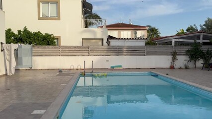 Larnaca, Cyprus – May 23, 2025: Private villa courtyard with swimming pool in spring weather