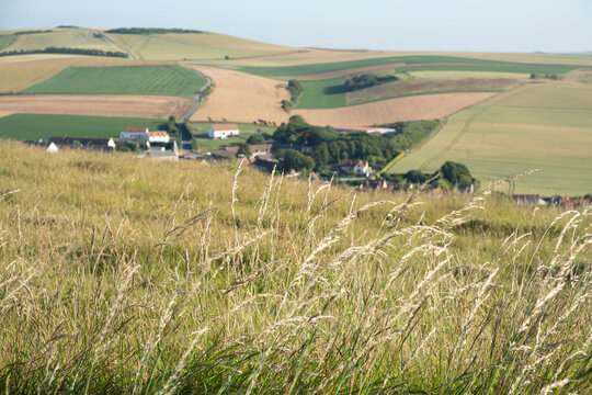Cap Blanc-Nez, Escalles, Pas-de-Calais, Hauts-de-France, France, July 29th, 2025, Experience a breathtaking view of the lush, rolling hills and a quaint village beautifully set under clear blue skies
