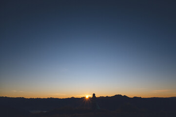 Hiker Silhouette Watching Sunrise from Isthmus Peak, Wanaka, New Zealand