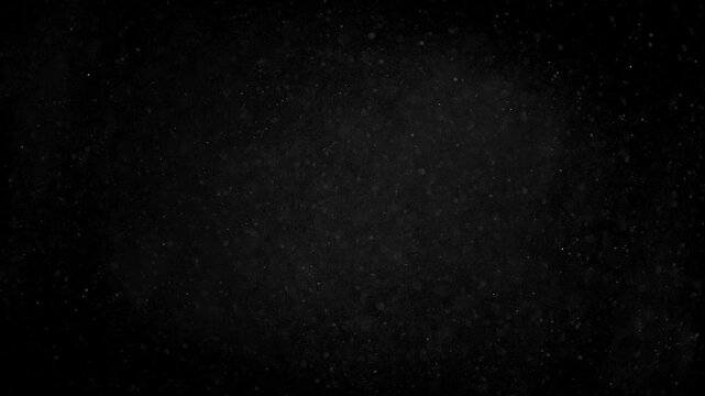 Air particles dancing in dark background. High quality 4k footage