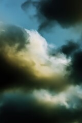 Fototapeta premium Dramatic dark clouds in a stormy sky with light peeking through