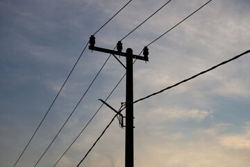 High voltage electric power lines and towers against a clear blue sky