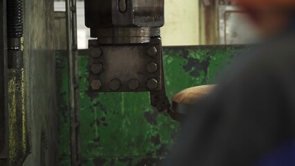 Industrial robotic arm stamping metal in factory. Stock clip