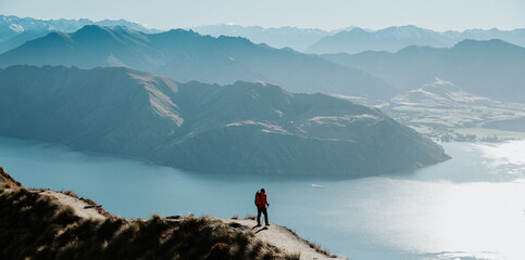Hiker Walking on Roys Peak Track Overlooking Lake Wanaka, New Zealand