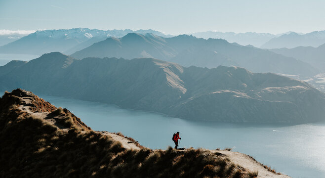 Hiker Walking on Roys Peak Track Overlooking Lake Wanaka, New Zealand