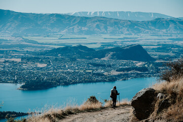 Hiker Walking on Roys Peak Track Overlooking Lake Wanaka, New Zealand