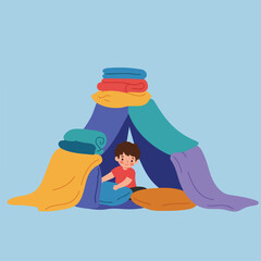 Young boy creating a fort with blankets and pillows on a light blue background