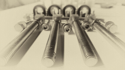 collage of screws, bolts and wrenches in black and white tones