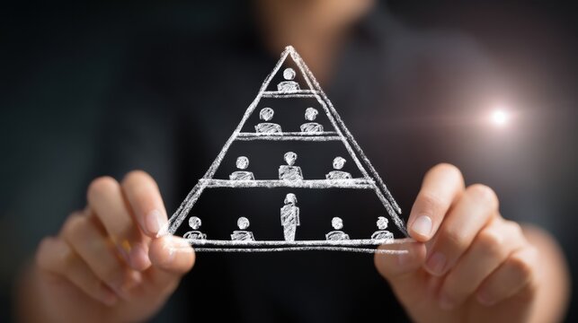 Woman hands drawing chalk pyramid with people symbolizing organizational hierarchy and leadership on dark background, conceptual business idea and teamwork visualization