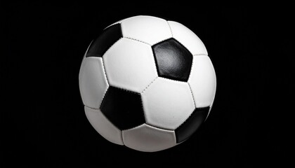 Fototapeta premium Classic black and white soccer ball with pentagon-hexagon pattern, isolated on solid black background