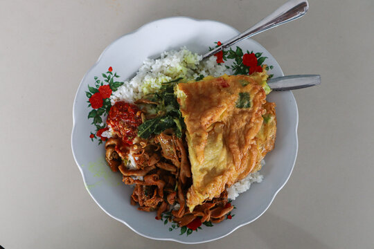 A typical Indonesian house made food. Cheap traditional and common food contains rice, vegetable, and omelette of a house restaurant (Warteg or Warung Tegal). Indonesia homemade food