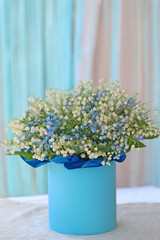 A beautiful floral arrangement with white and blue gypsophila in a gift box. Minimalistic decoration for home interior, celebration, or romantic occasion