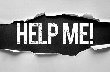 Torn paper reveals the bold, distressed words HELP ME! on a textured background, expressing urgency, plea, and a strong call for assistance, support, or rescue in a critical situation