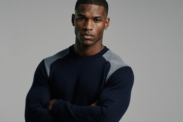 Obraz premium Confident male model in navy ribbed sweater portrait.