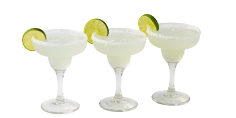 Refreshing Margaritas: Three elegant glasses are filled with a cool, vibrant margarita, garnished with a slice of fresh lime. Ideal for celebrating and relaxing.