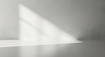 Minimalist interior with harsh sunlight casting geometric shadows on a textured wall and floor