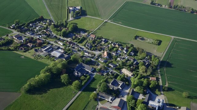 Aerial footage of rural urban area and fields in Denmark.