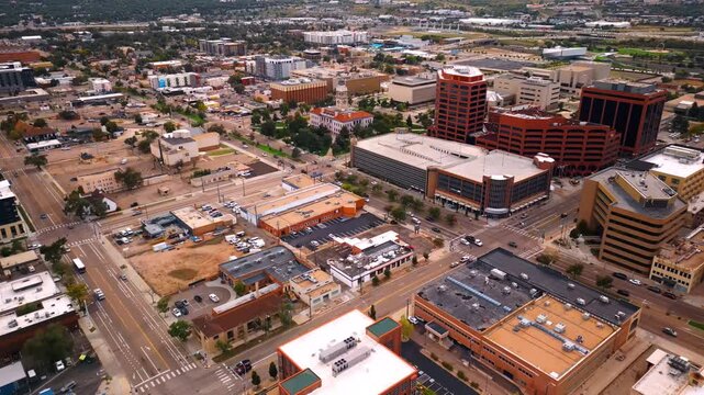 Vast cityscape of Colorado Springs, Colorado, USA. Numerous cars move by the wide highways of the urban landscape.