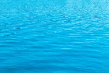 Rippling blue water surface at midday showcasing natural calmness