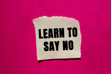Learn to Say No message written on ripped torn paper piece on pink background. Conceptual Learn to Say No symbol. Copy space.