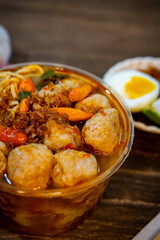 Bakso, Indonesian meatball soup, a culinary delight! Savory meatballs, spicy chilies, and egg create an authentic flavor journey. Perfect for food blogs, travel, and cuisine content.