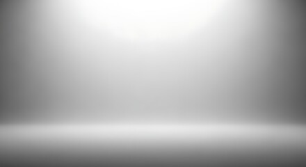 Empty studio background with soft spotlight illumination from above, creating a gradient effect