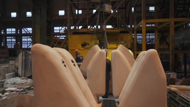 Foundry worker preparing sand mold for metal casting. Stock clip