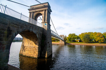 Obraz premium A view of Wilford Suspension bridge over the river Trent in Nottingham from the Victoria Embankment.