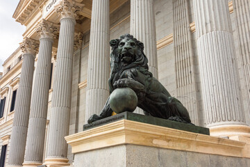 Statue of lion at Palace of Parliament (Congress of Deputies) in Madrid, Spain